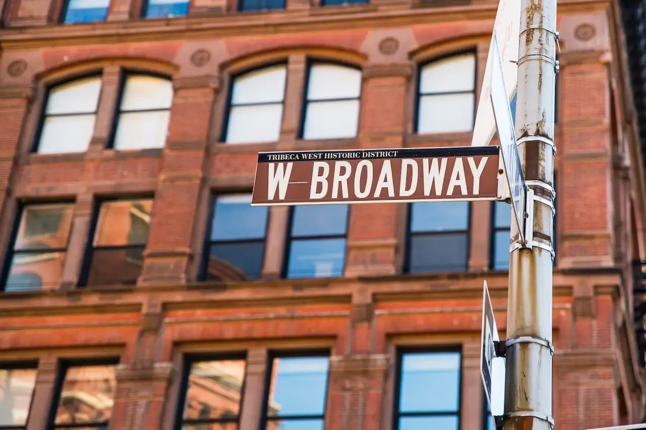 An image of a street sign that reads "Broadway" 