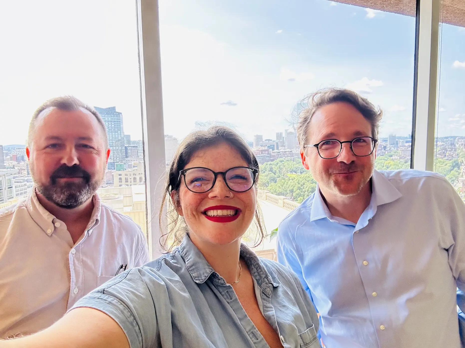 Members of the DockYard team taking a selfie in front of a window