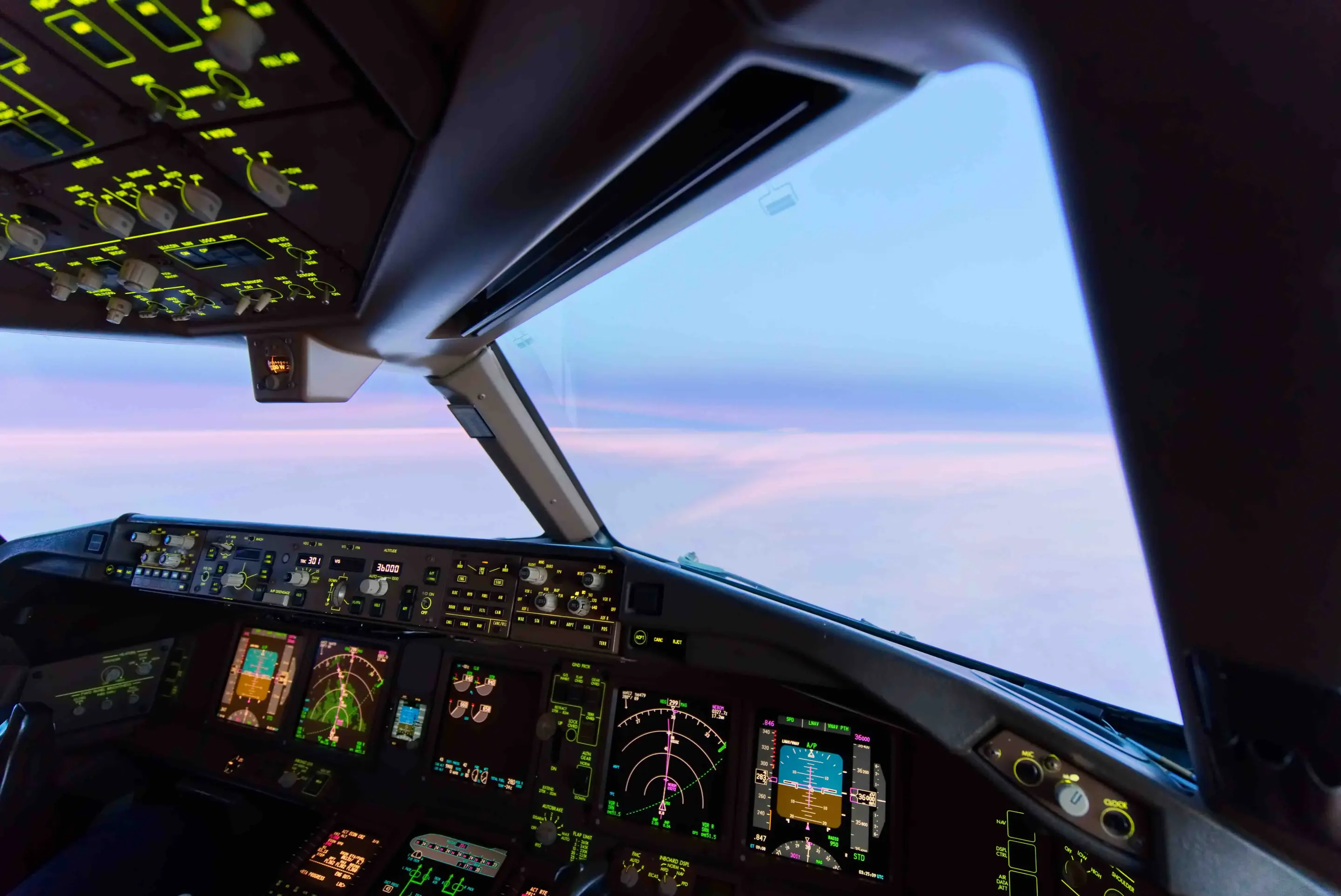 View of a pastel sky from the copilot seat of an airplane 