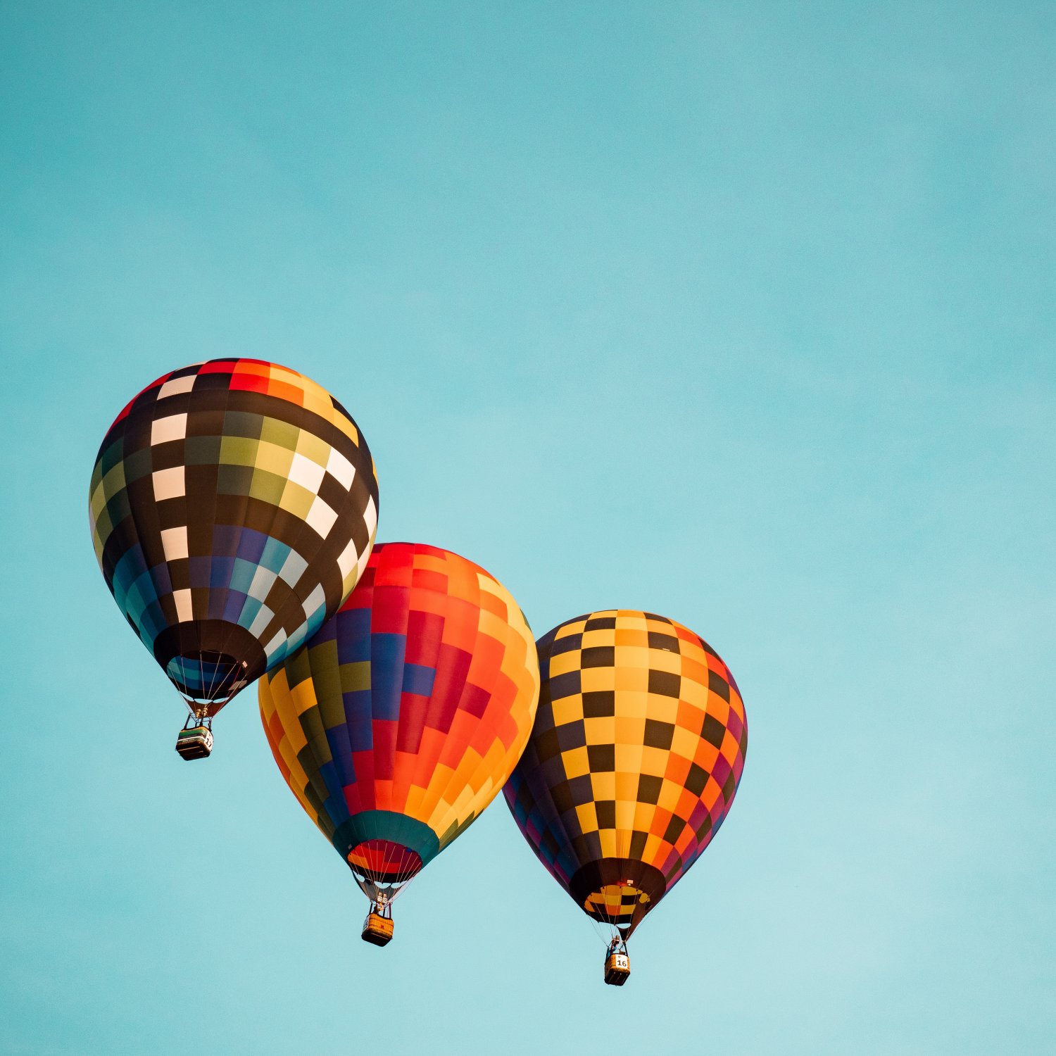 Three hot air balloons ascending