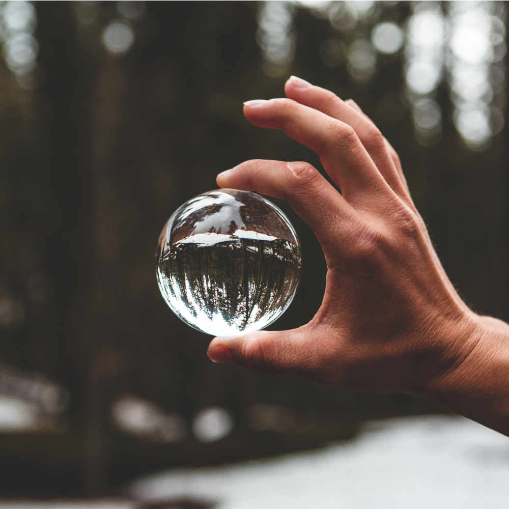 Hand holding magnifying ball