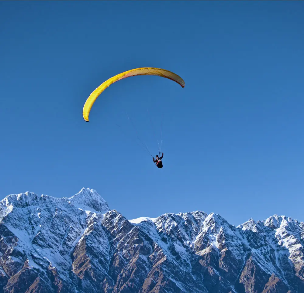 Person hanggliding over mountains
