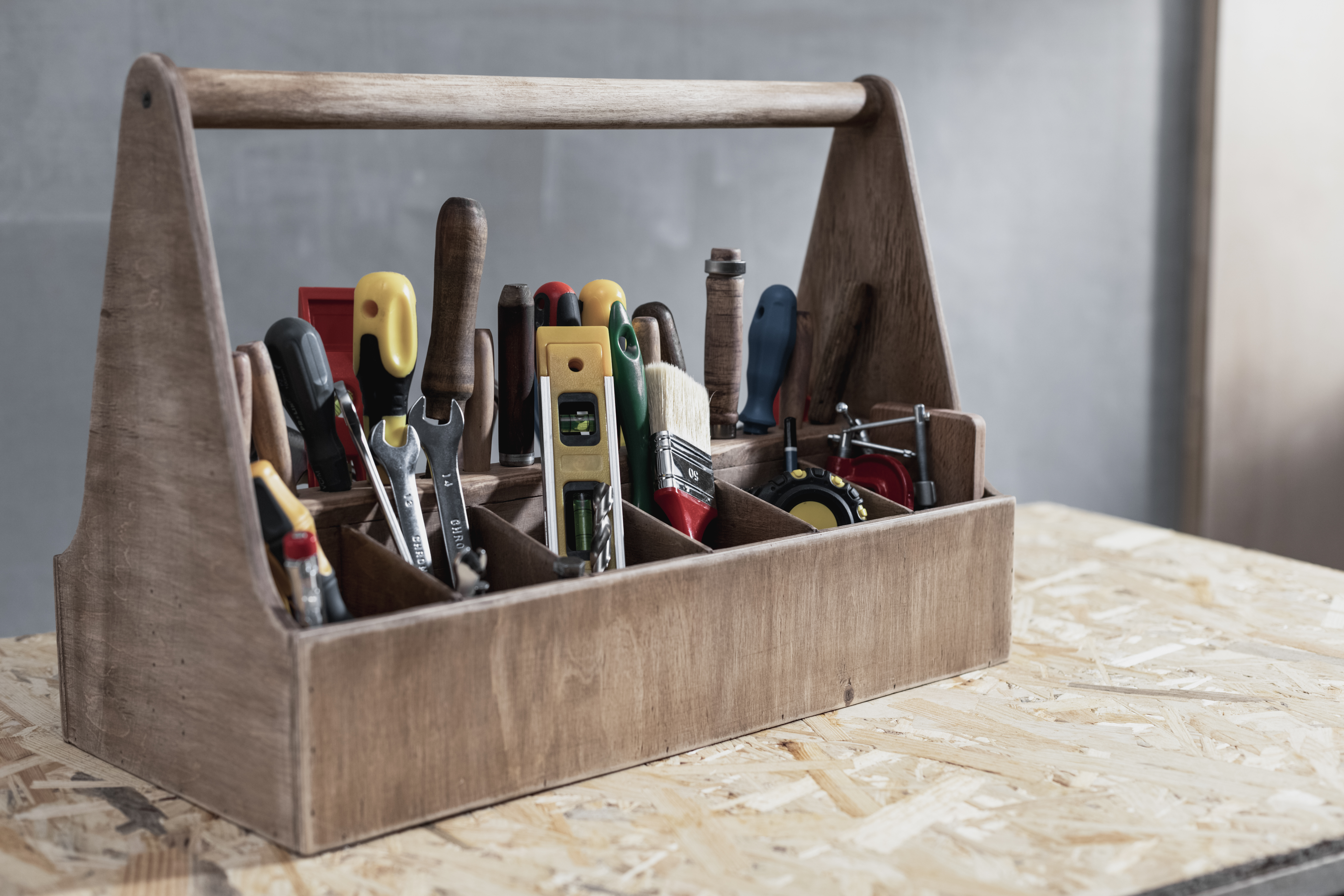 Box of tools on a wooden table
